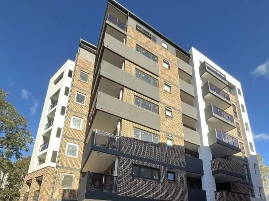 Contemporary apartment complex with balconies and brick facade in Australia.