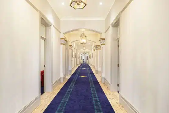 Bright hallway at Brighton Preparatory School, showcasing elegant decor and lighting.
